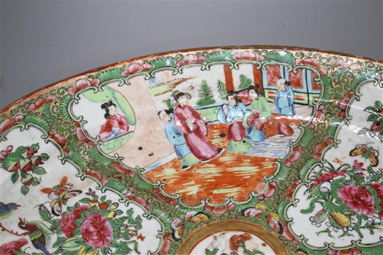 A 19th century Cantonese porcelain oval dish, decorated with panels of figures and birds, 42 x 34cm, height 4.5cm